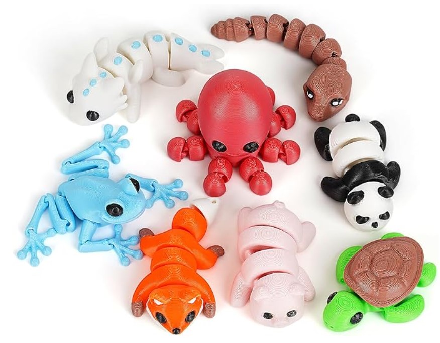 Colorful articulated 3D printed animals including frog, octopus, panda, turtle and fox arranged on a white background